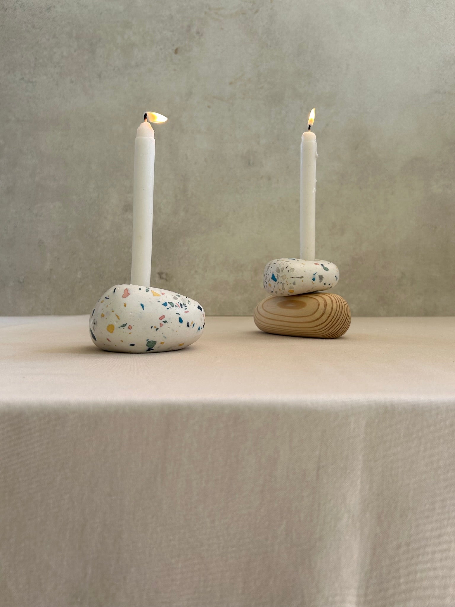A pair of handmade Pebble Candlestands. Crafted using wood and terrazzo. 